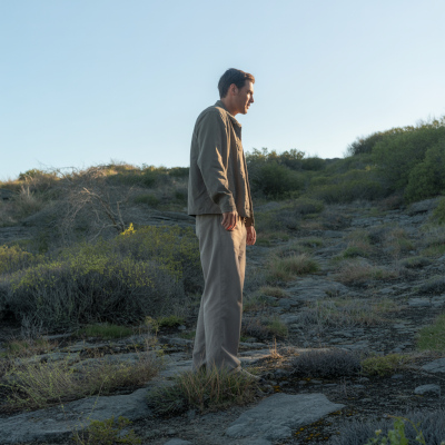 Ein Mann steht auf einen Hang und schaut in Richtung Sonnenaufgang